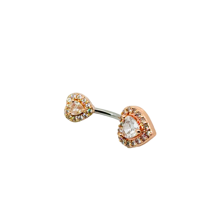 Heart-shaped navel bar with rose gold and clear gemstones on a white background