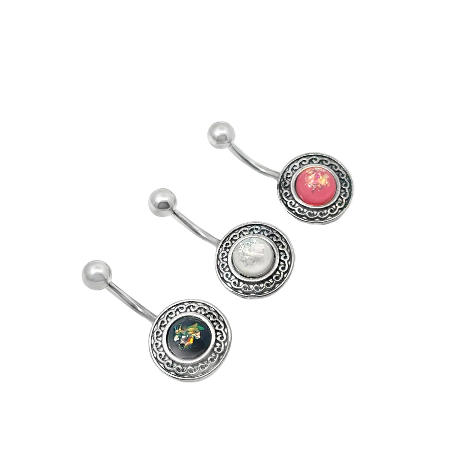 Three silver belly button bars with different colored gemstones on a white background
