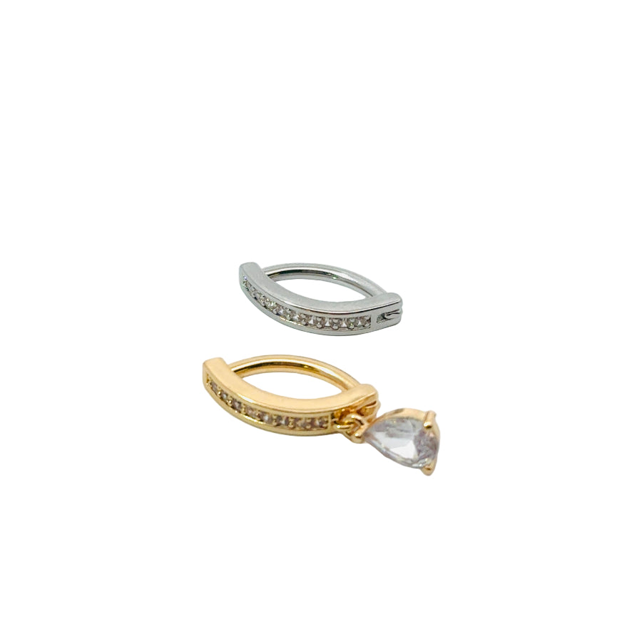 Gold and silver hoop navel rings with teardrop-shaped gemstones on a white background