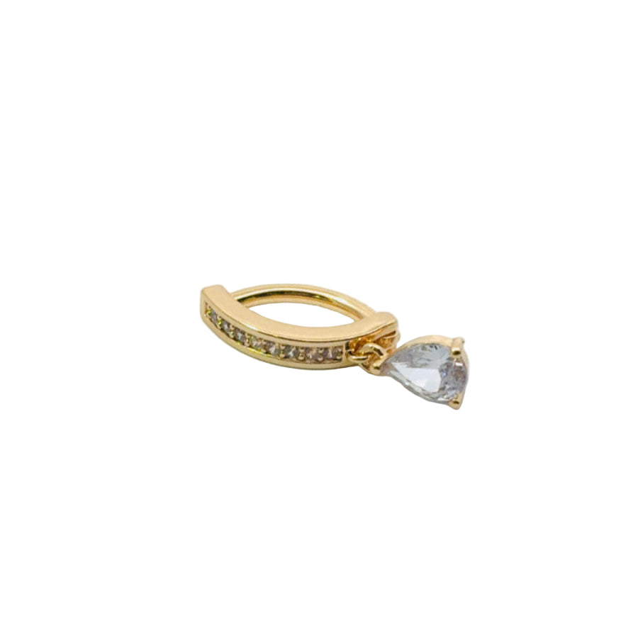 Gold ring with a teardrop-shaped diamond on a light gray background