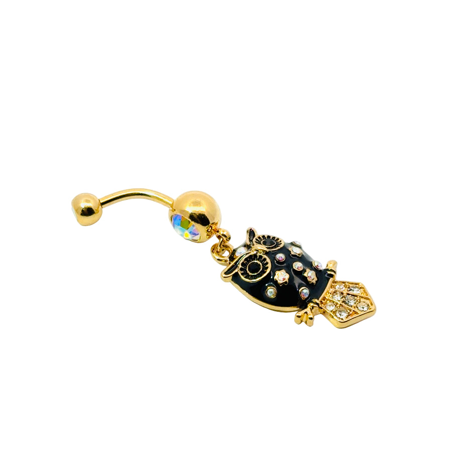 Gold and black owl-shaped belly button bar on a white background