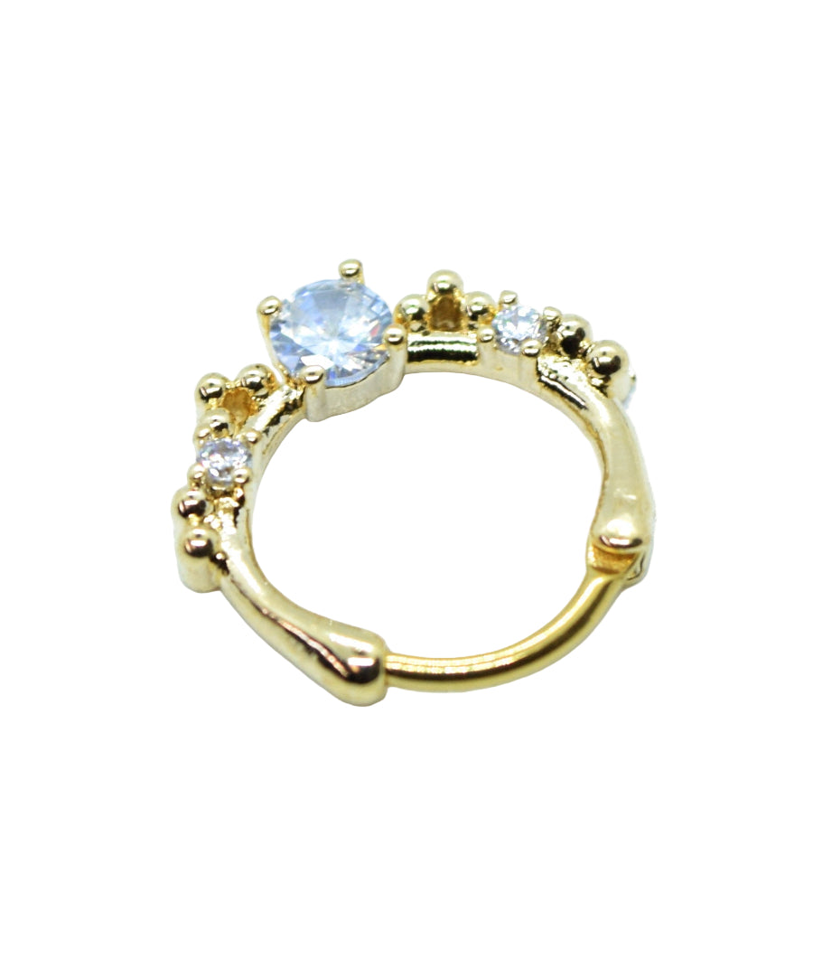 A gold-colored nose ring with a square-shaped diamante and small stone crystal embellishments.