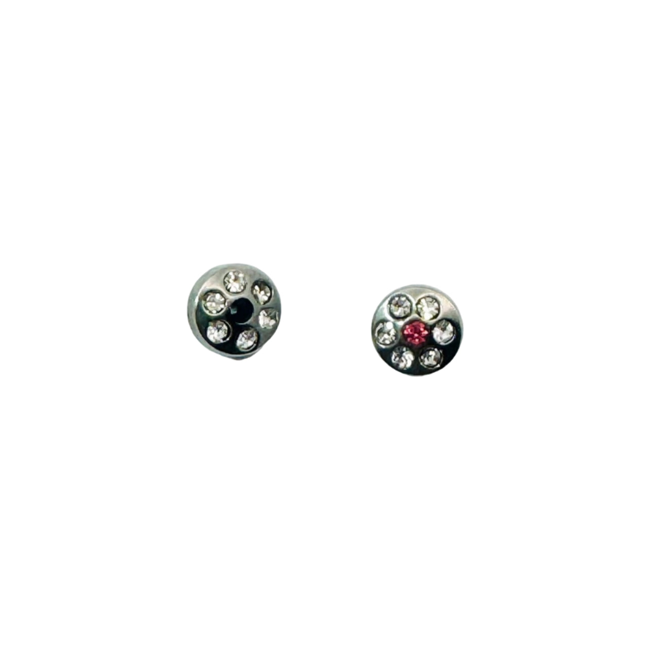 Pair of round dermal anchor toppers with gemstones on a white background