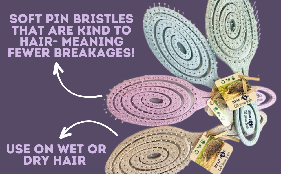 4 pastel coloured headjog branded hairbrushes splayed on a purple background 