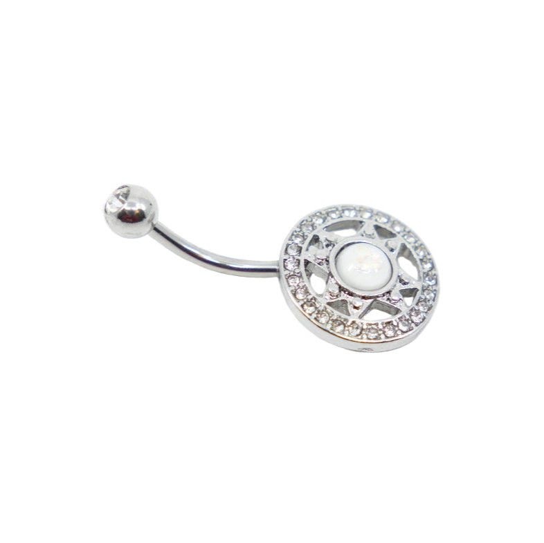 A 12MM navel bar piercing with a silver finish and a decorative circular end with a gemstone in the center.