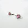 Belly button ring with pink gemstones on a white background