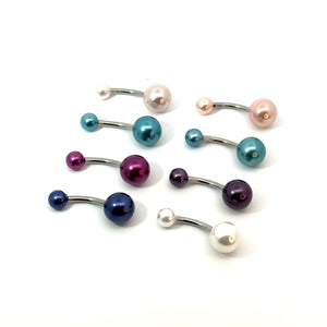 Set of colorful belly button rings on a white background