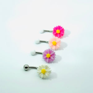 Set of four floral belly buttons on a white background