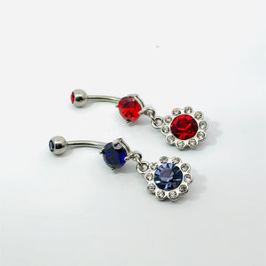 Belly button rings with red and purepl gemstones on a white background