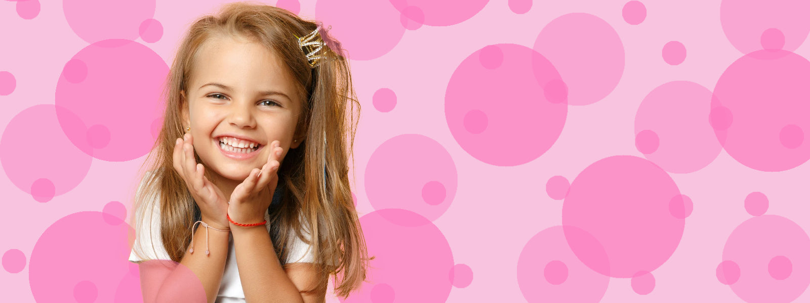 Young girl with a happy expression on a pink bubble background