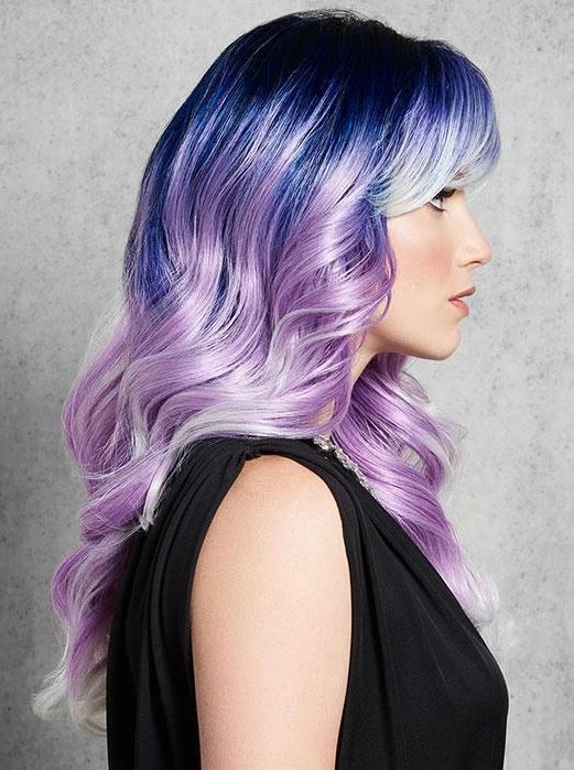 Woman with gradient hair color from blue to purple against a gray background