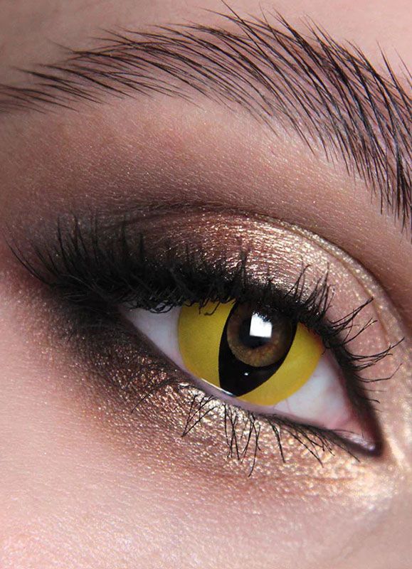 Close-up of a person's eye with dramatic makeup, featuring a yellow contact lens.