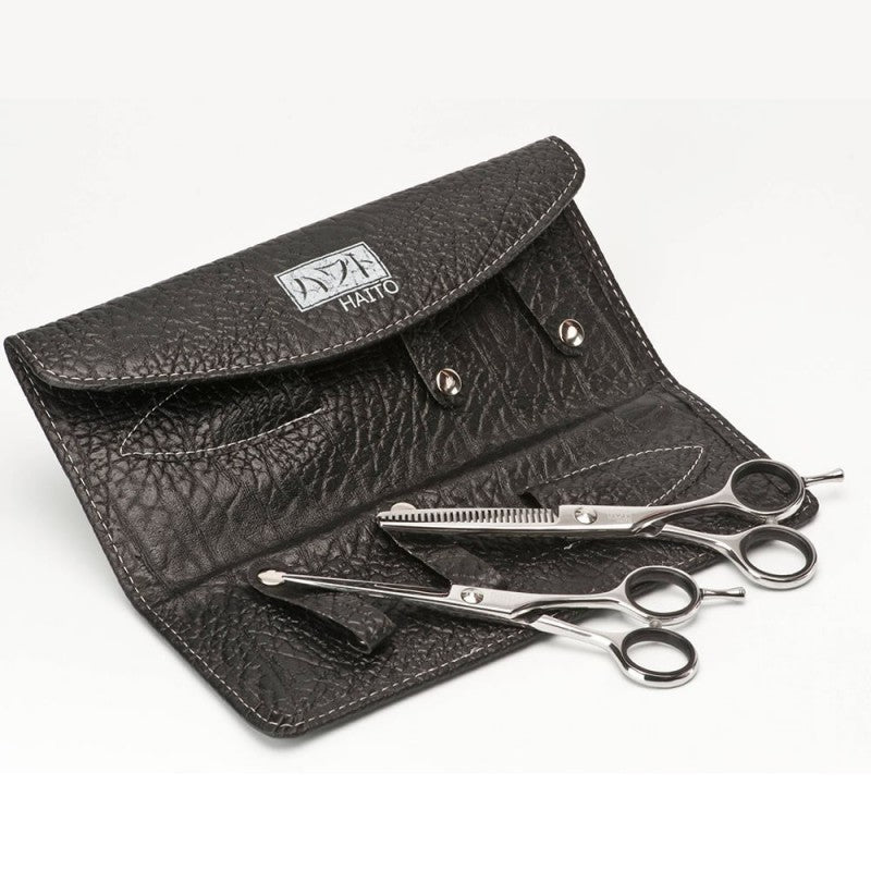 Black leather case with scissors on a white background