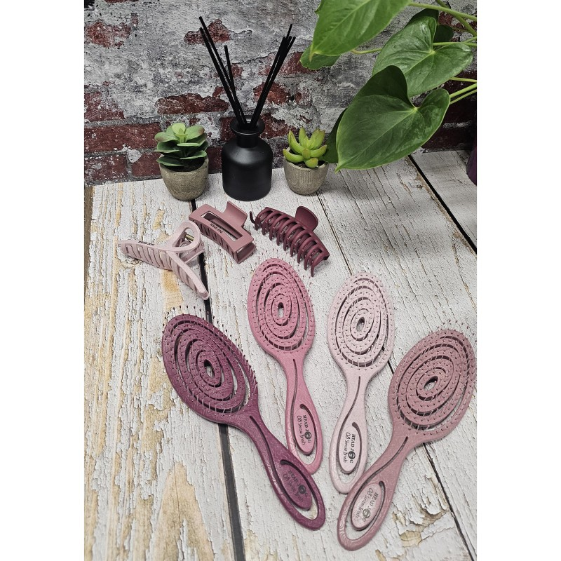 Pink toned brushes laid out on a wooden table