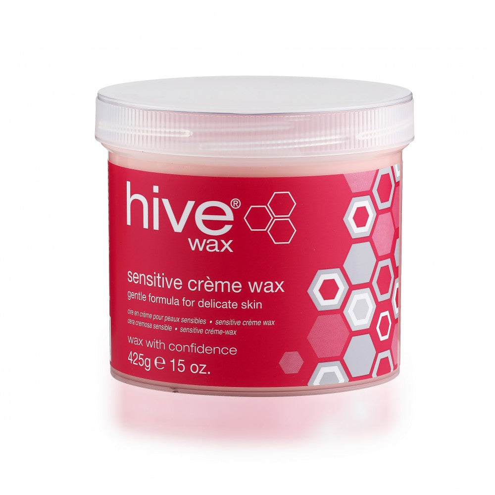 A container of Hive Sensitive Creme Wax with a pink lid and label design featuring honeycomb patterns and text indicating the wax is for delicate skin.