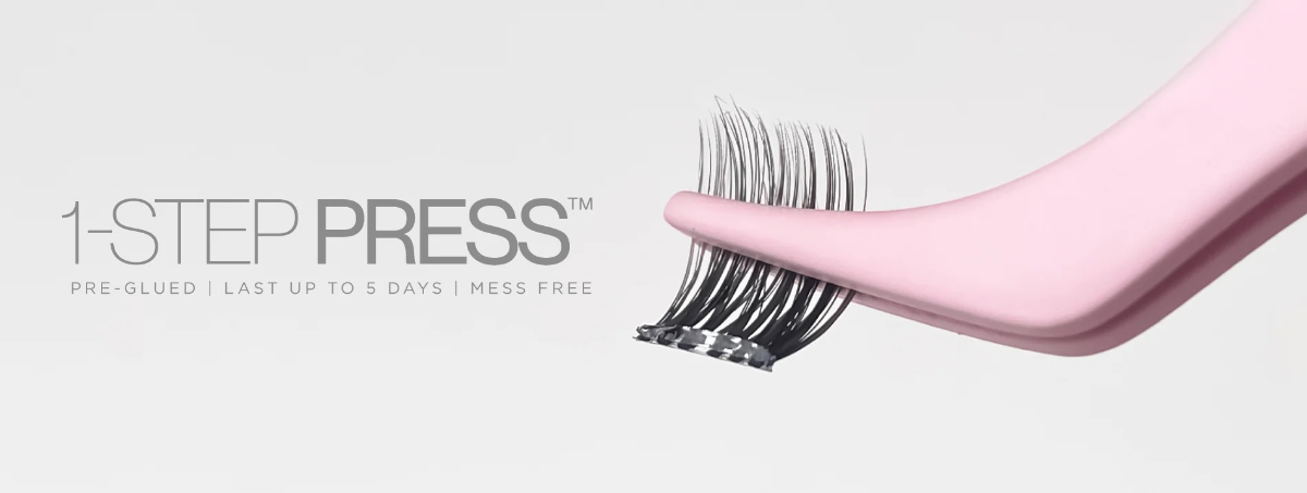 tatti lash single eyelash cluster held in a pair of pink tweezers