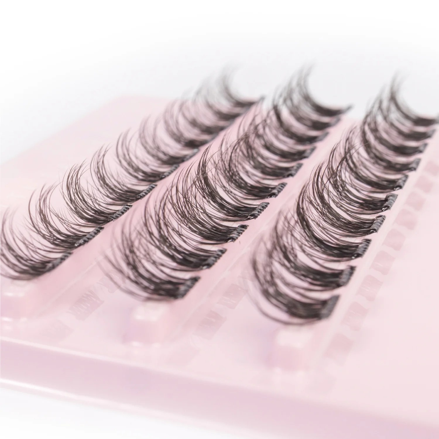 tatti lash eyelash clusters, closeup side shot in their pink backing packaging