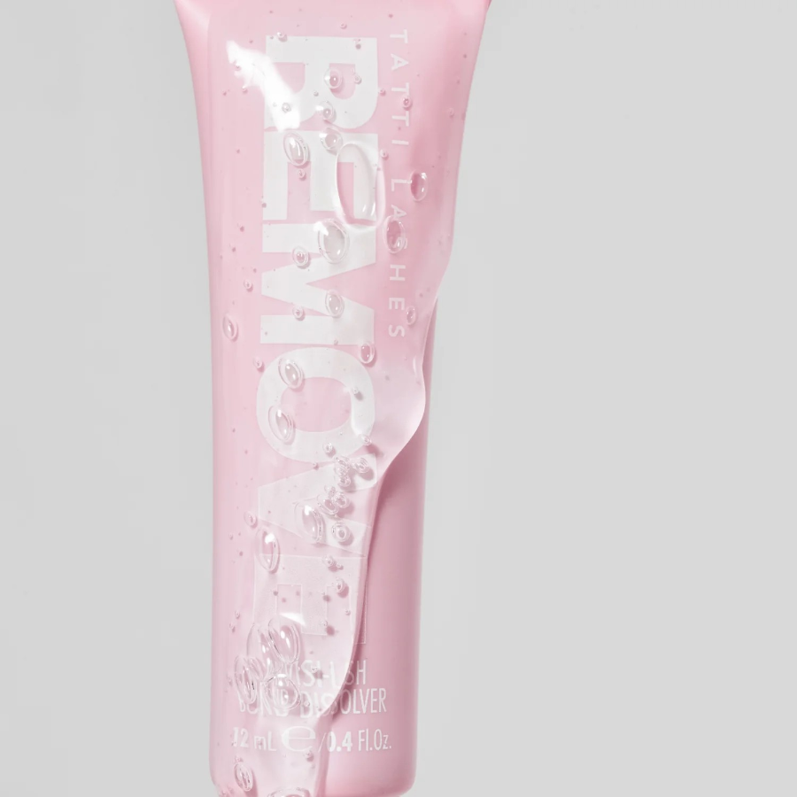 bottle of invisilash remover, close up with clea liquid covering and dripping down the tube