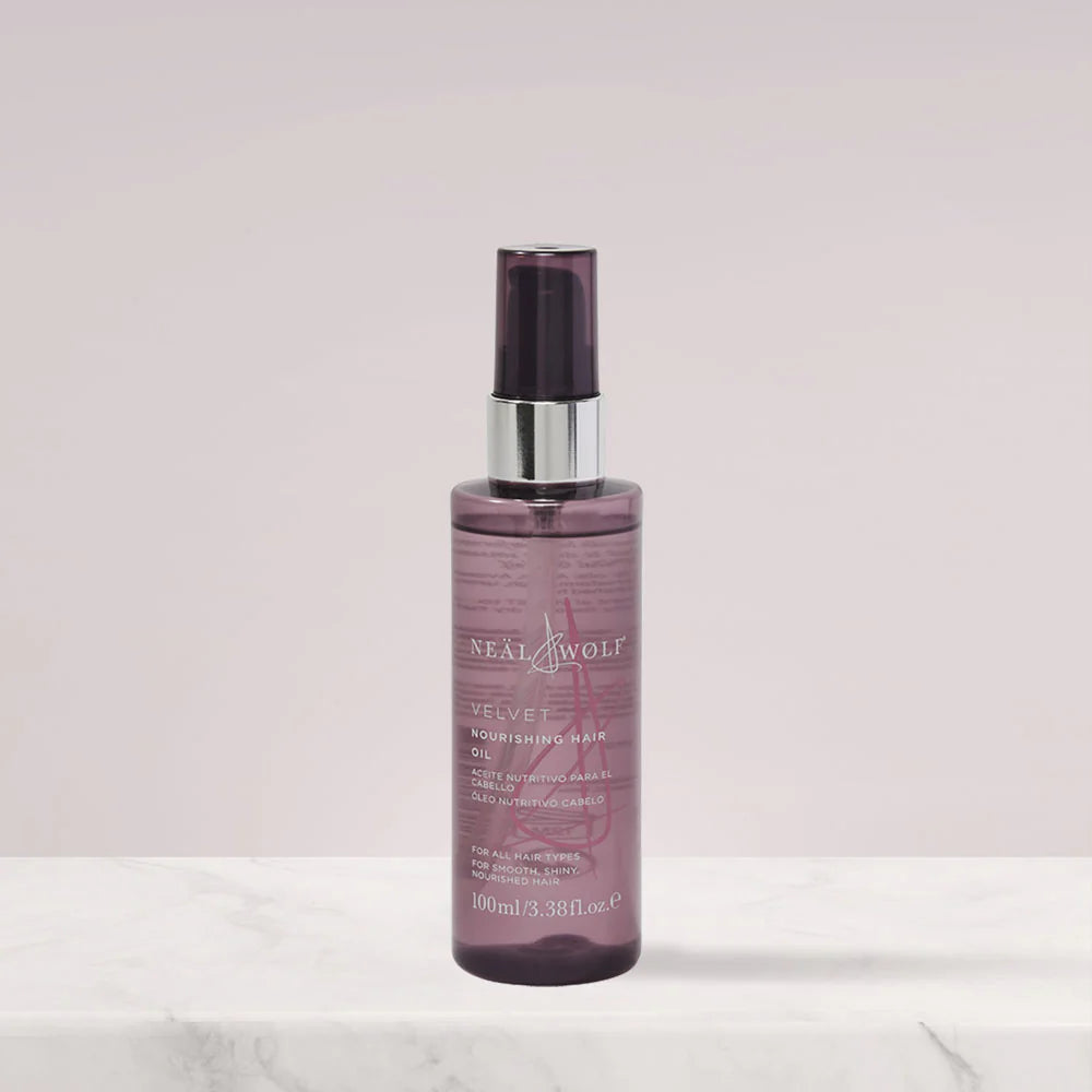 Neal & Wolf hair product bottle on a light pink background