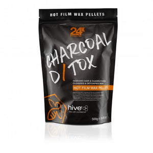 A black package of HIVE Charcoal Detox Hot Wax Pellets for sensitive skin waxing, with a resealable design and a label showing the product name and weight of 500g.