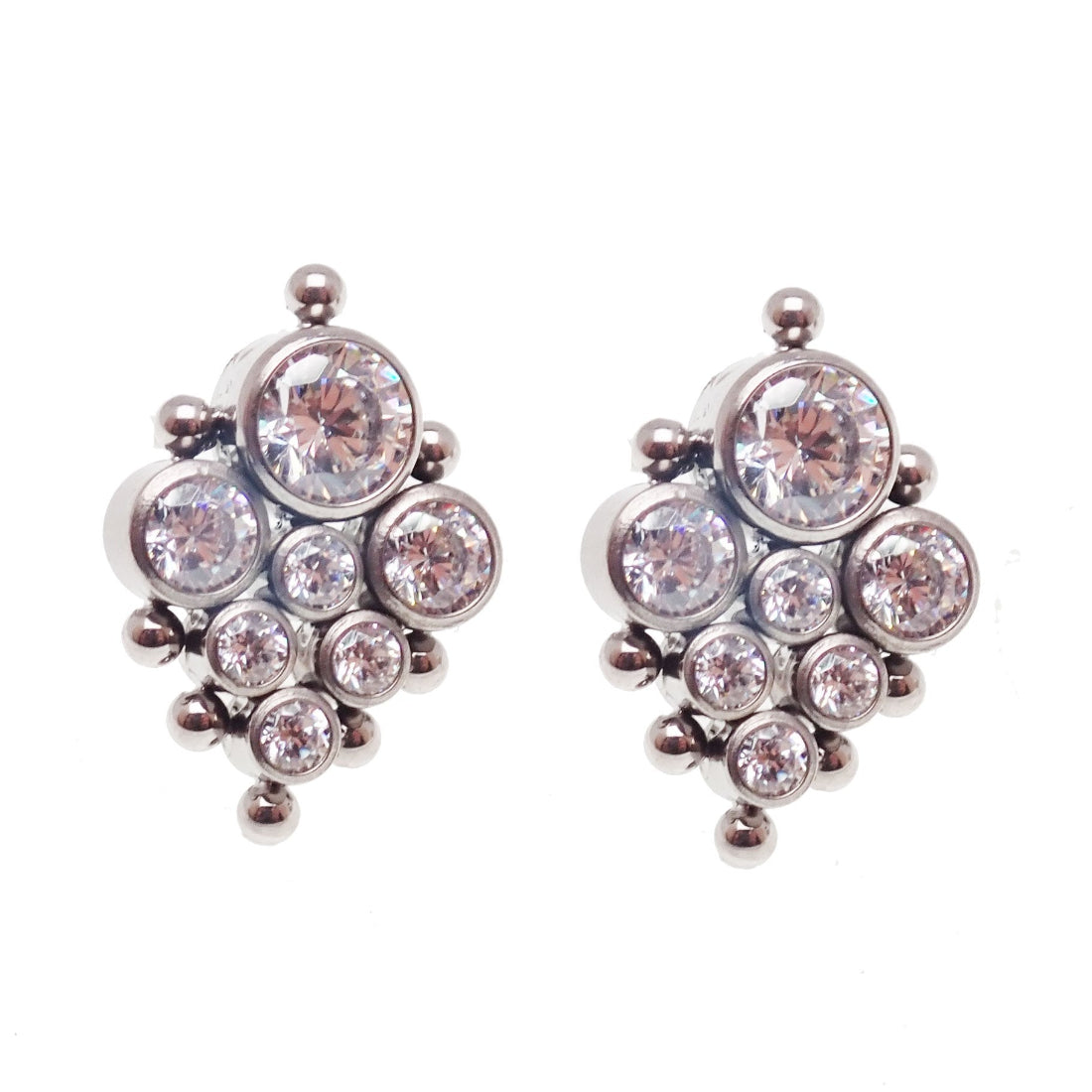 A pair of titanium earrings with bezel-set zircon crystals, featuring a high polish hand finish.