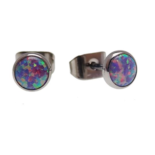 A pair of round titanium earrings with multicolored fire opal insets, bezel set, shown from a frontal view.